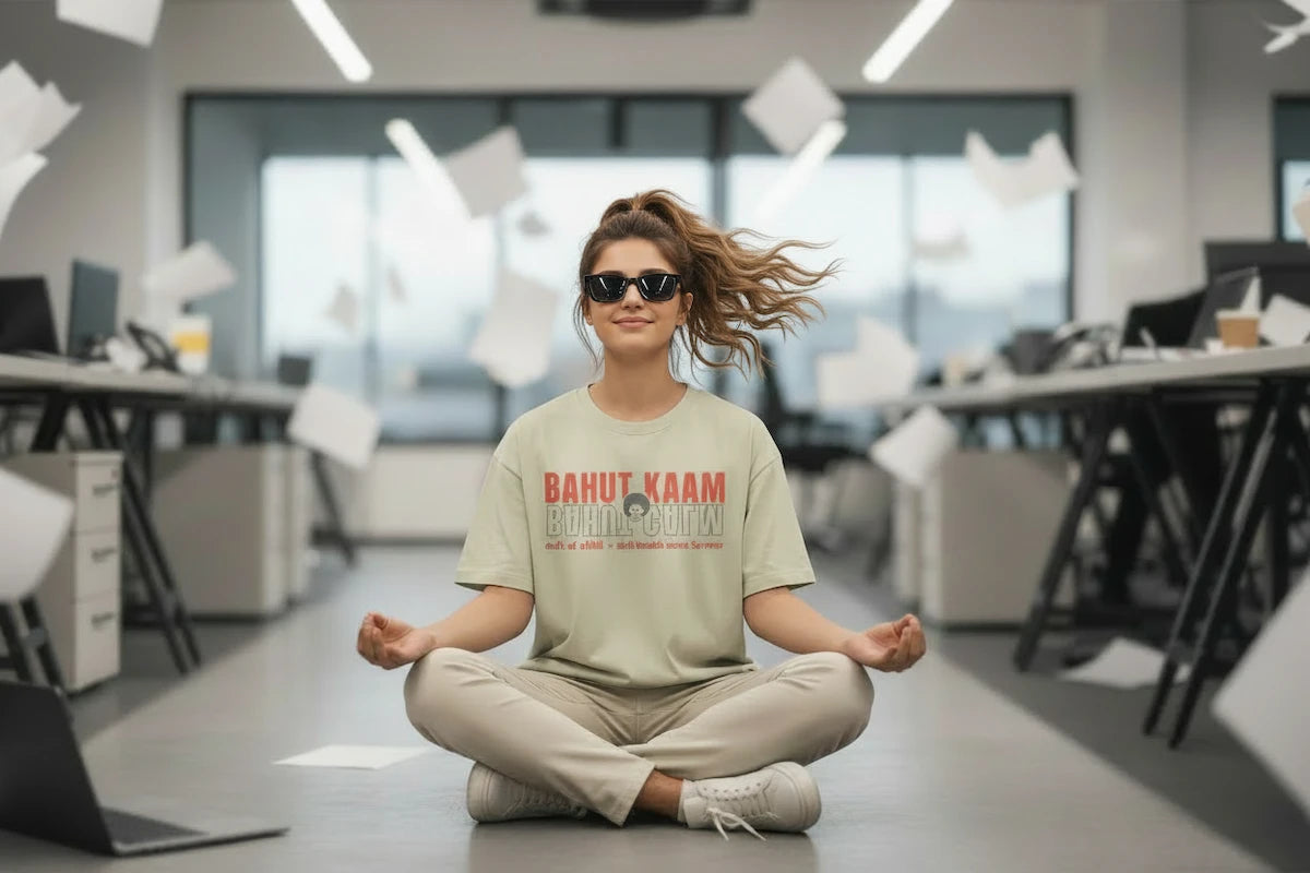 Model wearing oversized graphic tee in office setting — current edit by Cult of Chill